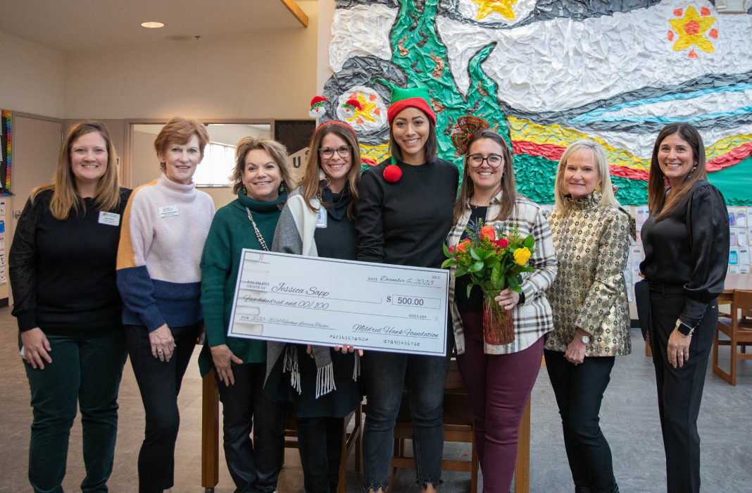 Evers Park staff holding a check